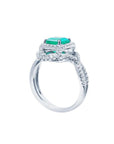 18K white gold ring with a vibrant emerald-cut emerald and sparkling halo diamonds.