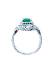 Emerald-cut natural emerald ring with halo diamonds on an 18K white gold band.