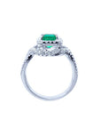 Emerald-cut natural emerald ring with halo diamonds on an 18K white gold band.