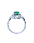 Emerald-cut natural emerald ring with halo diamonds on an 18K white gold band.