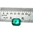Emerald-cut loose natura colombian emerald 1.41 ct. front side table and crown view with ruler sizer