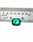 Emerald-cut 1.41 carat natural loose Colombian emerald, medium deep bluish green, shown with a ruler.