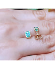 Emerald-cut natural Colombian emerald stud earrings, 1.29 ct, set in 14K yellow gold.