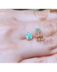 Emerald-cut natural Colombian emerald stud earrings, 1.29 ct, set in 14K yellow gold.