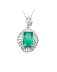 Emerald-cut emerald pendant in 14K white gold with natural diamonds, unique design.