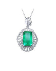 Emerald-cut emerald pendant in 14K white gold with natural diamonds, unique design.