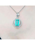 Emerald-cut Colombian emerald pendant with natural diamonds on a 14K white gold chain.
