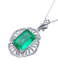 Emerald green gemstone pendant on a white background