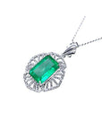 Emerald green gemstone pendant on a white background