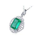 Emerald green gemstone pendant on a white gold chain, topside perspective view.