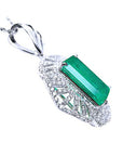 The underside view of a natural emerald-cut emerald pendant in white gold and accent diamonds.