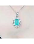 Emerald-cut Colombian emerald pendant with natural diamonds on a 14K white gold chain.