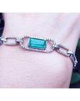 14K white gold paper clip bracelet with a rectangular Colombian emerald haloed by diamonds.