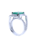 The left side of a 14k white gold emerald and diamond women's ring.