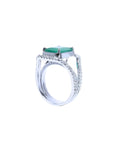 Emerald-cut 3.90 ct bluish-green emerald ring with triple diamond rows in 14K white gold.
