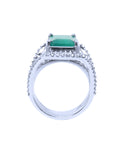 A lateral profile of a white gold emerald ring for women, top and gallery view.