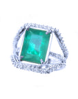 An emerald-cut natural emerald ring for women, on a top to left side profile.