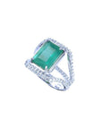 Emerald-cut 3.90 ct natural emerald ring with triple row diamond band in 14K white gold.