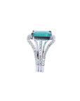 This ladies naturales emerald ring is displaying a side top and triple row of diamonds profile.