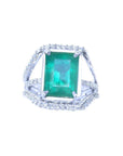 Emerald-cut natural colombian emerald ring for women with three rows of natural diamonds crafted in 14k white gold.