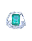 Emerald-cut natural colombian emerald ring for women with three rows of natural diamonds crafted in 14k white gold.