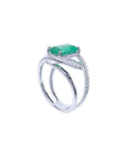 14K white gold ring with rectangular emerald-cut emerald and diamond split shank.