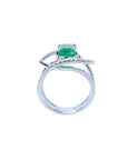Rectangular emerald-cut emerald ring with diamond double halo and split shank in 14K white gold.