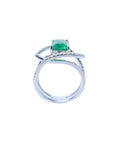Rectangular emerald-cut emerald ring with diamond double halo and split shank in 14K white gold.