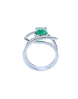 Rectangular emerald-cut emerald ring with diamond double halo and split shank in 14K white gold.