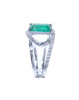 The side profile of this emerald and diamond ring shows a split shank.