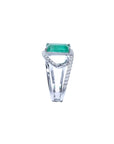 Rectangular emerald-cut emerald ring with diamond split shank in 14K white gold.