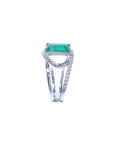 Rectangular emerald-cut emerald ring with diamond split shank in 14K white gold.