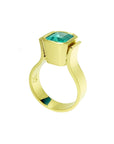 Emerald-cut emerald solitaire ring, bezel set in high polish 14K gold with a unique band design.