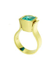 Emerald-cut emerald solitaire ring, bezel set in high polish 14K gold with a unique band design.