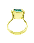 The lateral position of this yellow gold emerald solitaire ring shows the top setting and ring band.