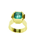 Emerald-cut emerald solitaire ring, bezel set in high polish 14K gold.