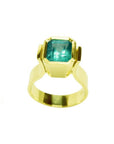 Emerald-cut emerald solitaire ring, bezel set in high polish 14K gold.