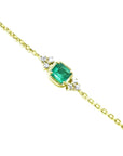 14k yellow gold bracelet with a 0.85 ct medium green emerald and six natural diamonds.