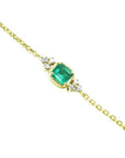 14k yellow gold bracelet with a 0.85 ct medium green emerald and six natural diamonds.