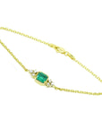 14k yellow gold emerald bracelet with a rectangular green emerald and six natural diamonds.