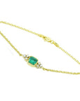 14k yellow gold emerald bracelet with a rectangular green emerald and six natural diamonds.