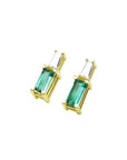 Minimalist 14K gold stud earrings with baguette emeralds and tapered diamond accents.