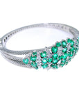 14k White gold bangle bracelet with round cut natural colombian emeralds and diamonds for women.