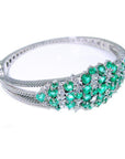 14k White gold bangle bracelet with round cut natural colombian emeralds and diamonds for women.