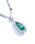 Colombian pear cut emerald necklace with a rich, deep green hue, set in 18K white gold and double halo diamonds.