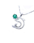 14K white gold dolphin pendant with a round deep green emerald and sparkling accents.