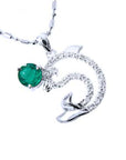A solid white gold emerald dolphin pendant with natural diamonds.