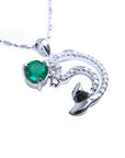 Emerald dolphin pendant with a round cut natural emerald and diamonds in white gold.