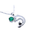 Emerald dolphin pendant with a round cut natural emerald and diamonds in white gold.