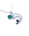 Emerald dolphin pendant with a round cut natural emerald and diamonds in white gold.